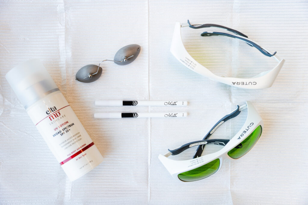 protective eyewear, a bottle of SPF, and markers laying on a counter. These are supplies necessary the Excel V in Plano, a laser treatment that eliminates the appearance of bulging veins.