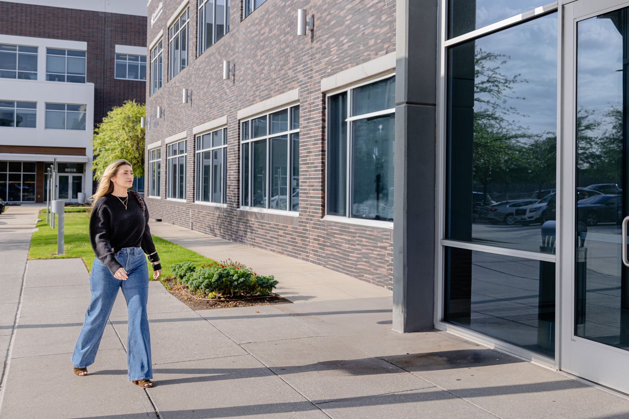 Woman walking confidently into a weight loss clinic in Plano to discuss her recent transformation and how to maintain the results with her provider.