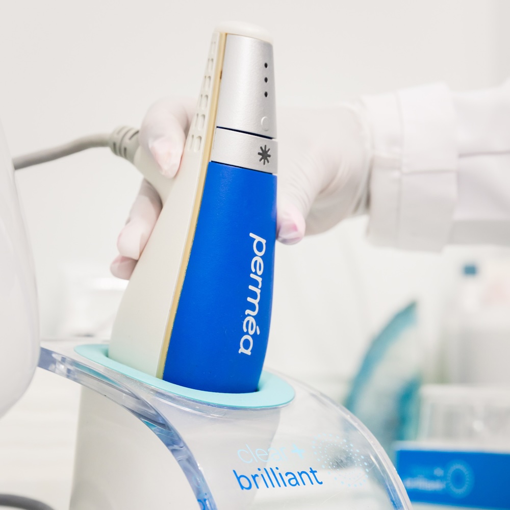 Med Spa provider wearing gloves grabs the Clear and Brilliant laser near Prosper.